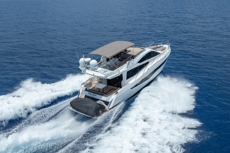 Slide: The Image of 2017 Galeon 550 Fly yacht cruising on open blue sea, aerial view. - 2