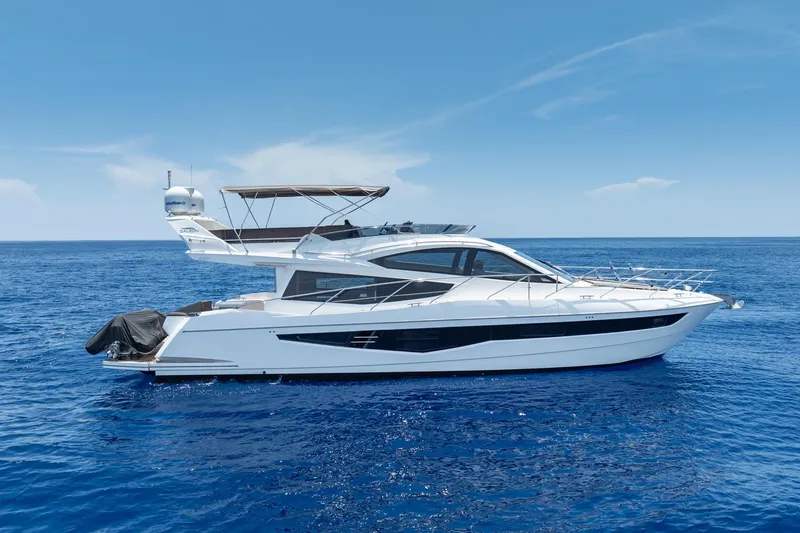 Slide: The Image of 2017 Galeon 550 Fly yacht cruising on open blue sea under clear sky. - 9