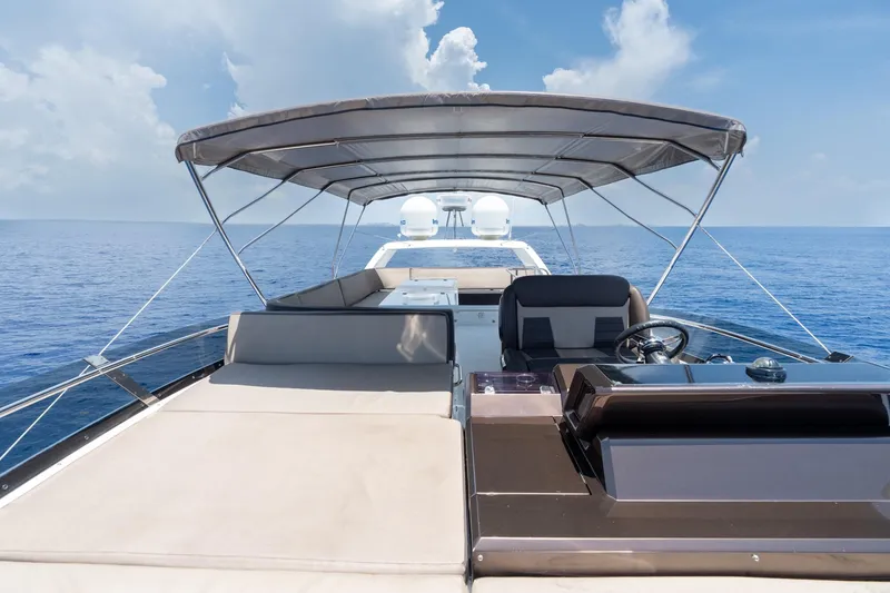 Slide: The Image of 2017 Galeon 550 Fly yacht deck with canopy, cruising on calm blue ocean. - 20