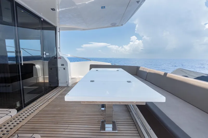 Slide: The Image of Outdoor dining area on 2017 Galeon 550 Fly yacht with ocean view. - 17