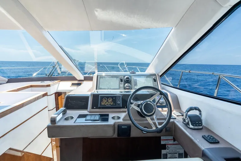 Slide: The Image of Cockpit view of 2017 Galeon 550 Fly yacht with ocean backdrop. - 44