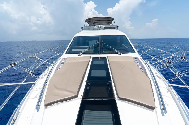 Slide: The Image of 2017 Galeon 550 Fly yacht on open sea, featuring sunbathing pads and sleek design. - 12