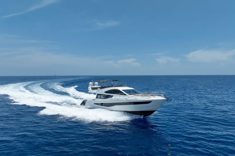 Slide: The Image of 2017 Galeon 550 Fly yacht cruising on open blue sea under clear sky. - 5