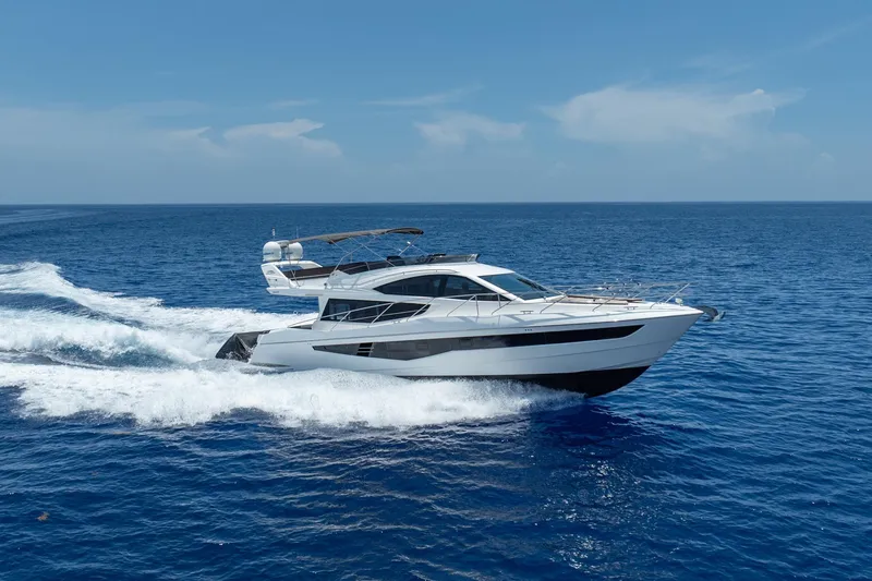 Slide: The Image of 2017 Galeon 550 Fly yacht cruising on open blue sea under clear sky. - 4
