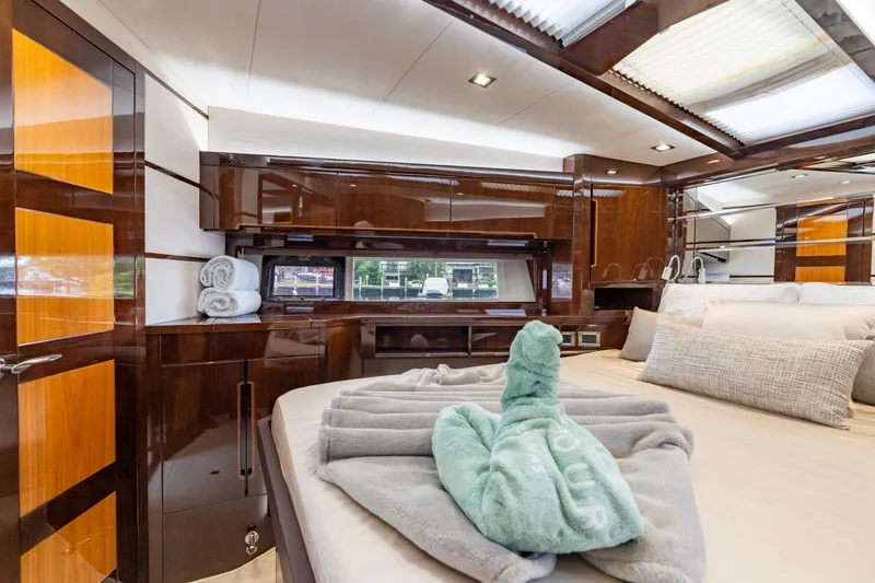 Slide: The Image of Luxurious interior of 2017 Galeon 550 Fly yacht with elegant wood finishes and plush bedding. - 55