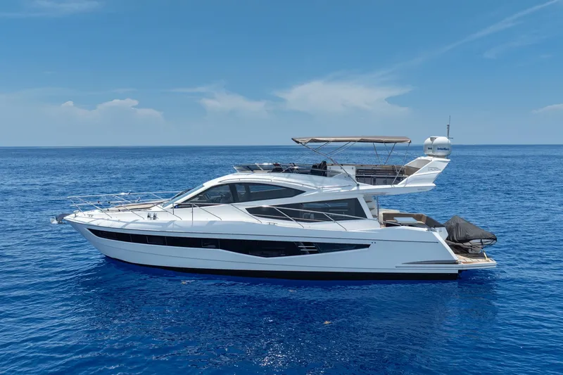 Slide: The Image of 2017 Galeon 550 Fly yacht cruising on open blue sea under clear sky. - 10