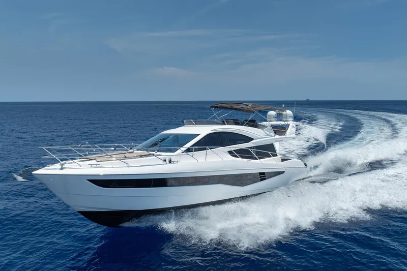 Slide: The Image of 2017 Galeon 550 Fly yacht cruising on open sea under clear blue sky. - 3