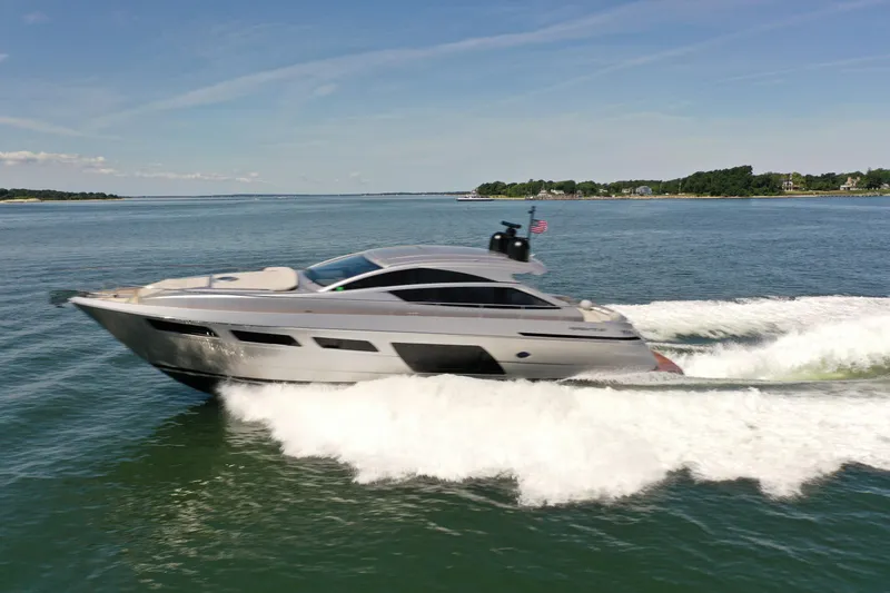The Image of A sleek motorboat speeds across the water, surrounded by a calm coastal landscape. - 0