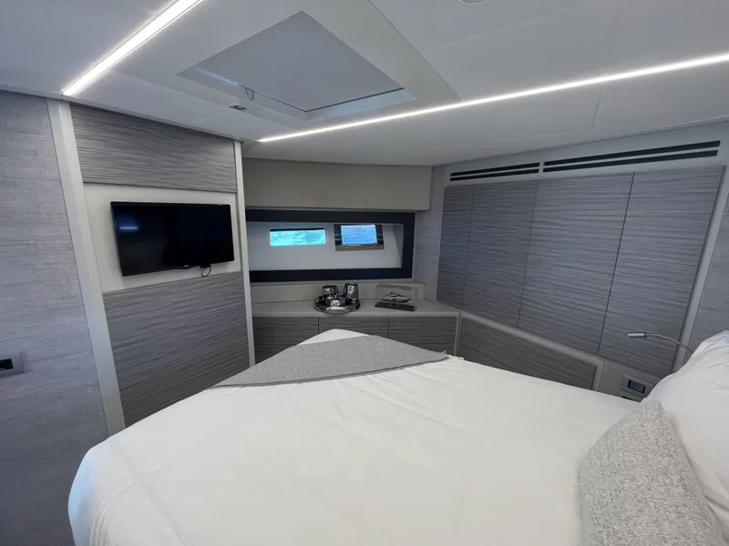 Slide: The Image of Luxurious cabin with modern design, flat-screen TV, and window view of the water. - 14