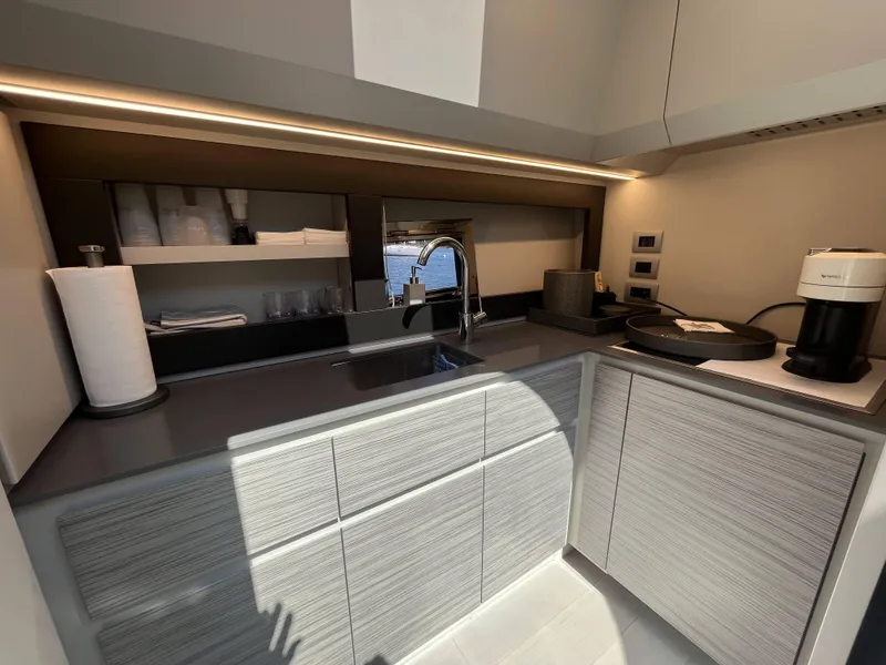 Slide: The Image of Modern kitchenette on a Pershing 6X yacht with a sink and coffee maker. - 17
