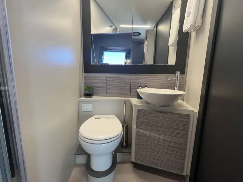Slide: The Image of Modern bathroom on a Pershing 6X yacht with toilet, sink, and mirror. - 18