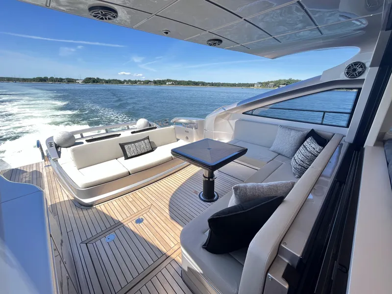 Slide: The Image of Luxurious boat with sleek seating and table on deck, surrounded by water. - 19