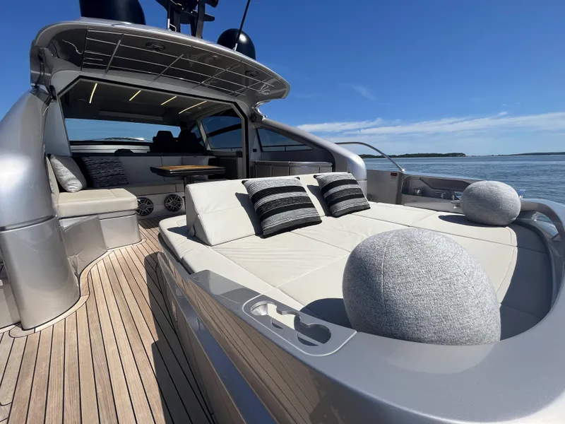 Slide: The Image of Luxurious sun deck of a Pershing 6X yacht with cushions, on calm water. - 24
