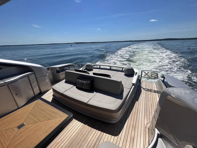 Slide: The Image of Luxurious boat with sleek seating area on the water, surrounded by blue sky and calm sea. - 27