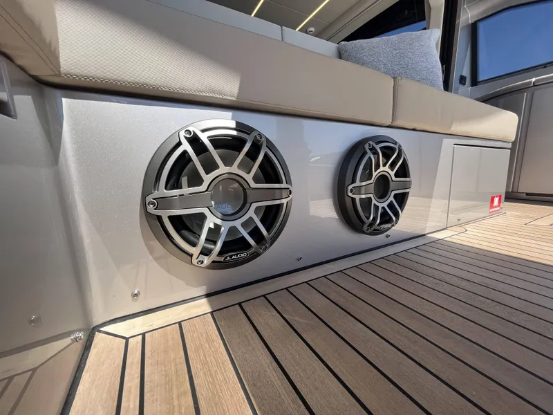 Slide: The Image of Close-up of speakers on a modern boat with wooden flooring and beige upholstery. - 30