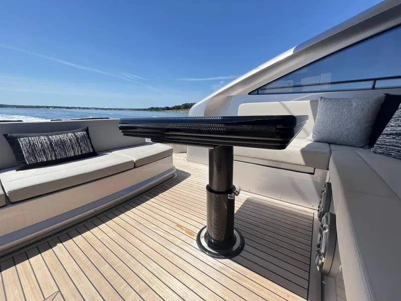 Slide: The Image of Luxurious boat with sleek seating and table on deck, surrounded by water. - 34