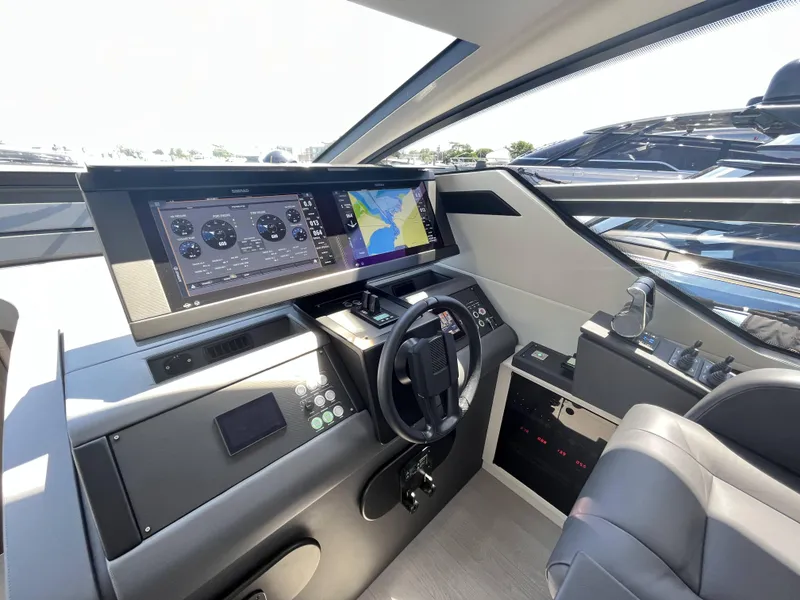 Slide: The Image of The cockpit of a modern yacht with controls and navigation screens. - 37