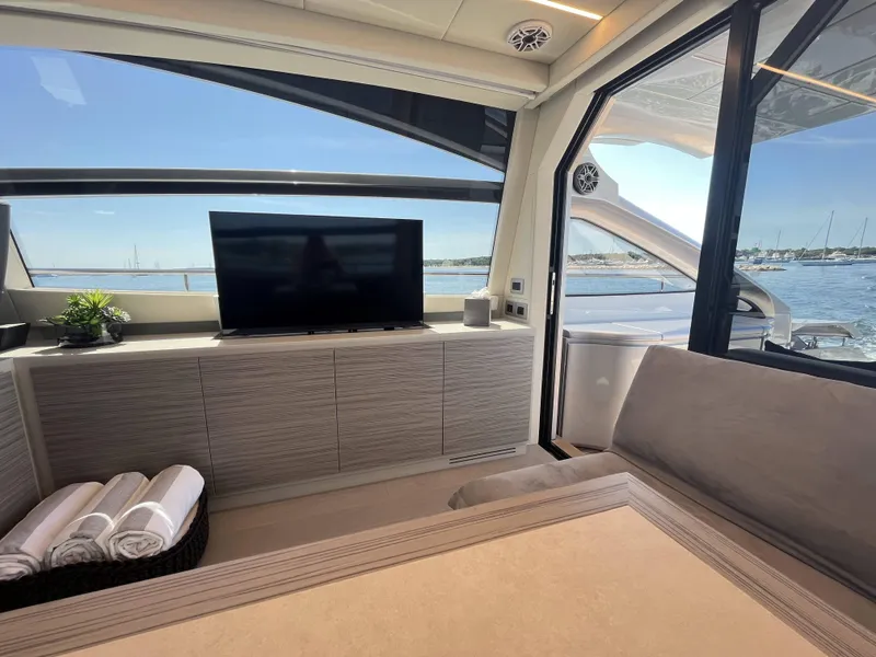 Slide: The Image of Interior of a modern yacht with a TV, sofa, and view of the water. - 7