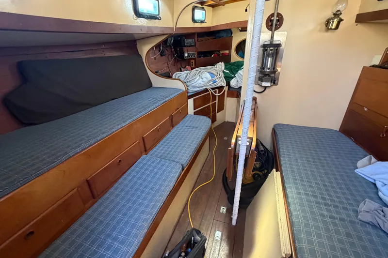Slide: The Image of Interior of 1991 Hylan Offshore Steel Cutter with blue cushioned seating and wooden cabinetry. - 1