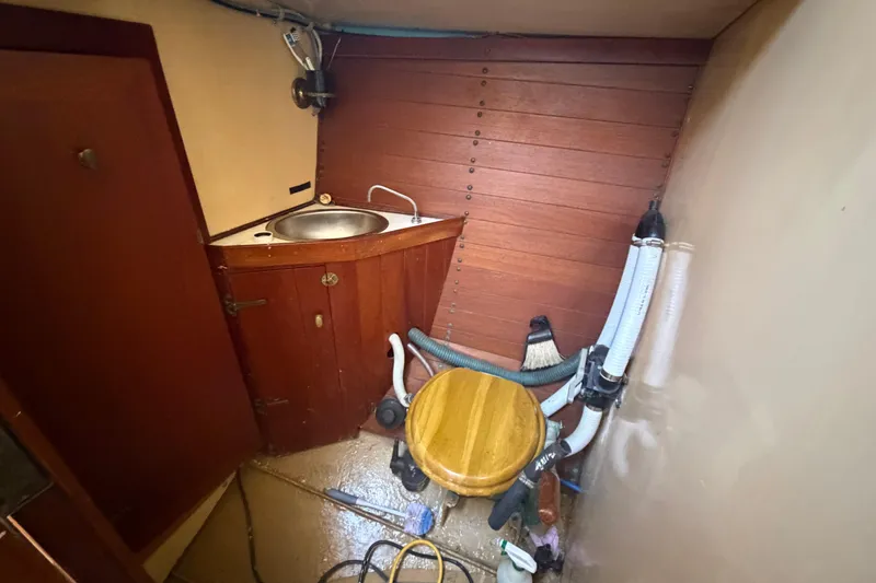 Slide: The Image of Interior of 1991 Hylan Offshore Steel Cutter with wooden cabinetry and compact sink area. - 10