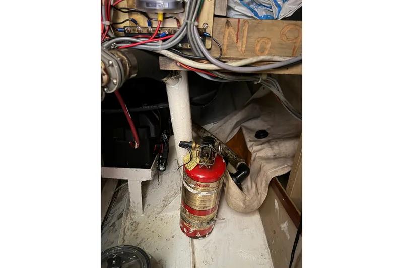 Slide: The Image of Fire extinguisher in engine room of 1991 Hylan Offshore Steel Cutter boat. - 13