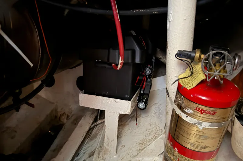 Slide: The Image of Engine room of 1991 Hylan Offshore Steel Cutter with battery and fire extinguisher. - 14