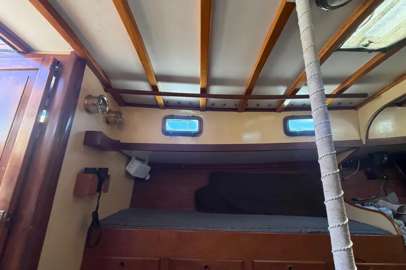 Slide: The Image of Interior of 1991 Hylan Offshore Steel Cutter with wooden beams and cozy sleeping area. - 16