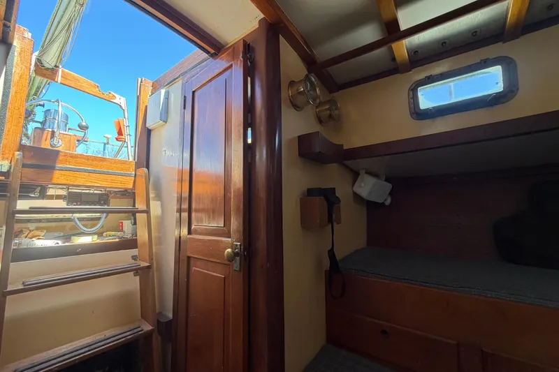 Slide: The Image of Interior of 1991 Hylan Offshore Steel Cutter, featuring wooden ladder and cozy cabin space. - 17