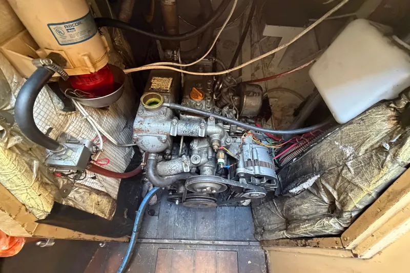 Slide: The Image of Engine compartment of a 1991 Hylan Offshore Steel Cutter, showcasing mechanical components and wiring. - 20