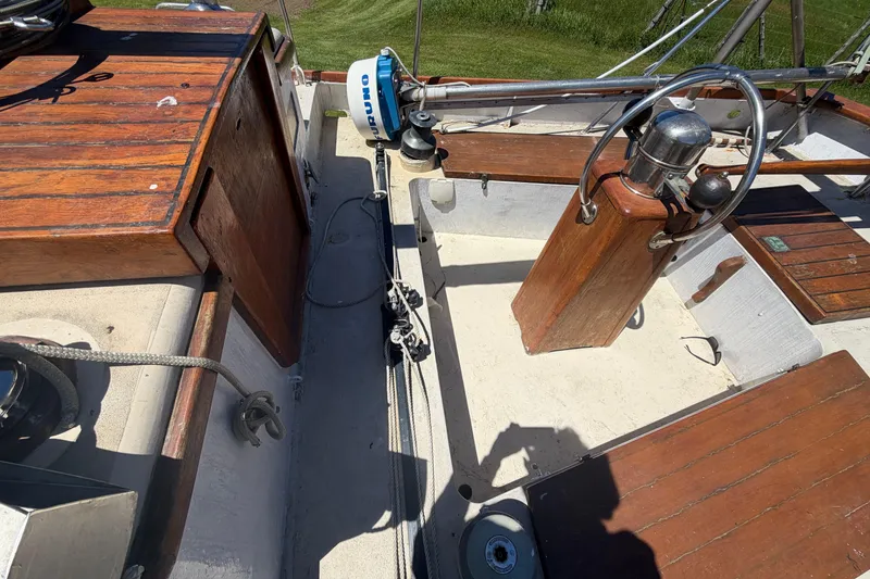 Slide: The Image of 1991 Hylan Offshore Steel Cutter deck with wooden accents and steering wheel. - 22