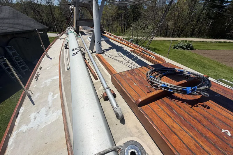 Slide: The Image of 1991 Hylan Offshore Steel Cutter deck with wooden accents and coiled ropes. - 23