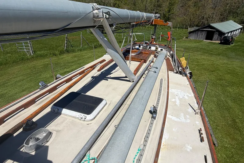 Slide: The Image of 1991 Hylan Offshore Steel Cutter sailboat on grassy field, mast and deck visible. - 27