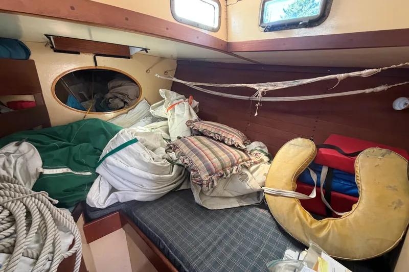 Slide: The Image of Interior of a 1991 Hylan Offshore Steel Cutter with nautical gear and cushions. - 4
