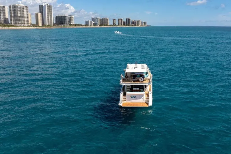 Slide: The Image of Azimut 70 yacht cruising near a coastal city skyline, 2011 model. - 103