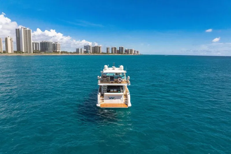 Slide: The Image of Azimut 70 yacht from 2011 on blue ocean, city skyline in background. - 119