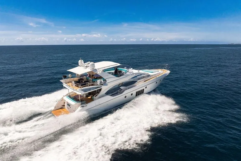 Slide: The Image of Luxurious 2011 Azimut 70 yacht cruising on open sea under clear blue sky. - 122