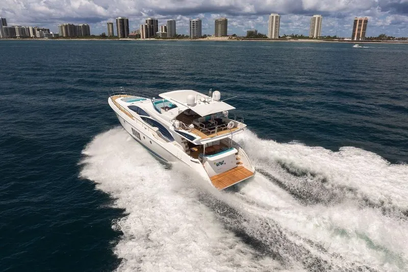 Slide: The Image of Azimut 70 yacht cruising on ocean near city skyline, 2011 model. - 125