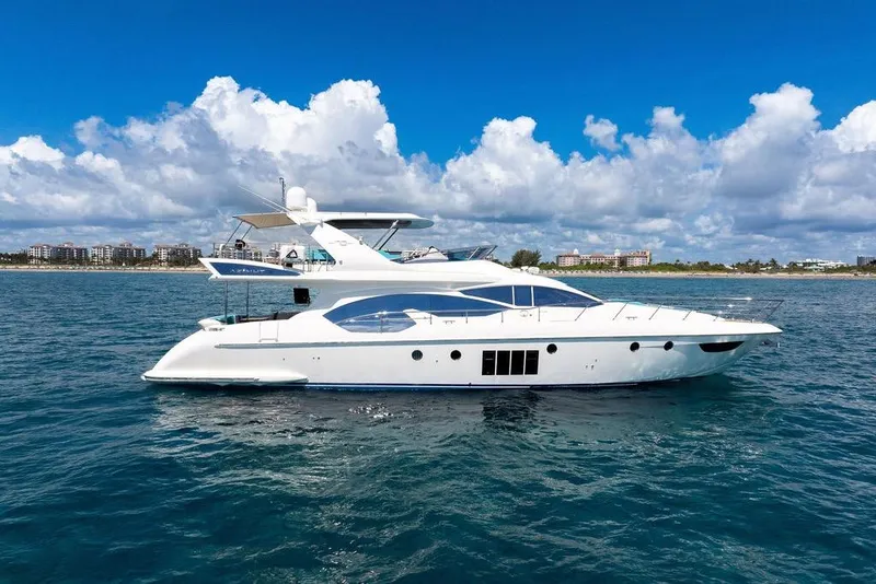 Slide: The Image of Luxury 2011 Azimut 70 yacht cruising on open water under a clear blue sky. - 2