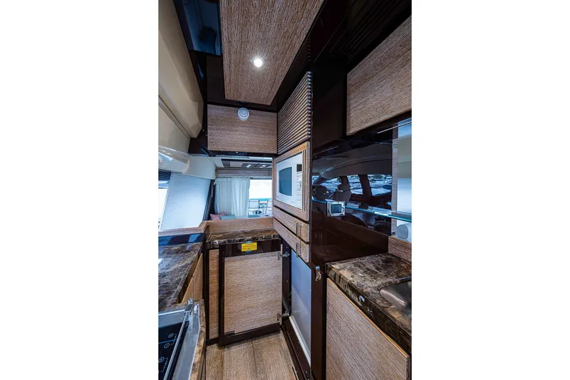 Slide: The Image of Luxurious interior of 2011 Azimut 70 yacht kitchen with modern appliances and wood finishes. - 30
