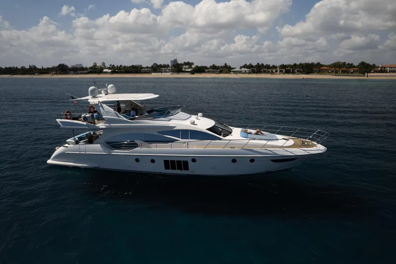 Slide: The Image of Luxury 2011 Azimut 70 yacht cruising near scenic coastline under cloudy sky. - 6