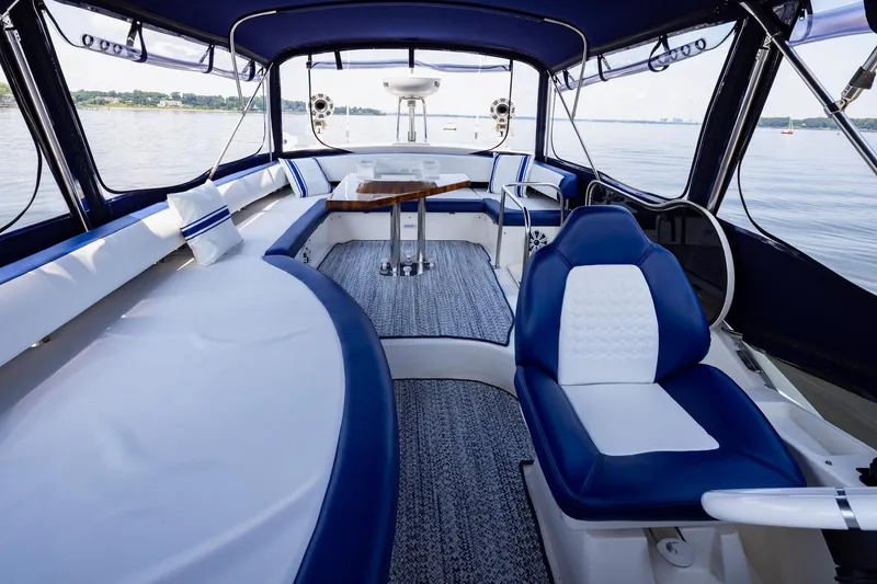 Slide: The Image of Luxurious 2007 Azimut 43 yacht interior with blue and white seating, overlooking calm waters. - 12