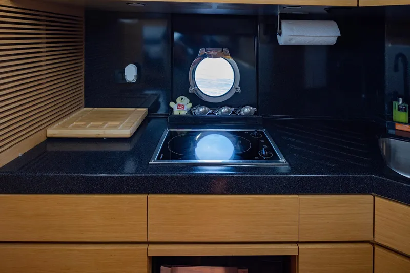 Slide: The Image of Modern kitchen interior of 2007 Azimut 43 yacht with stove and porthole window. - 16