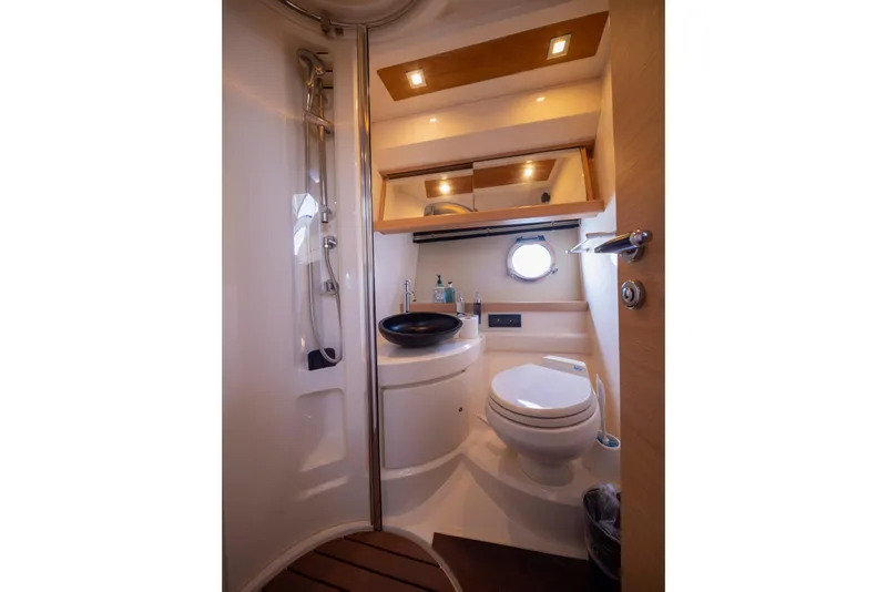 Slide: The Image of Luxurious bathroom interior of 2007 Azimut 43 yacht with modern fixtures and porthole window. - 17