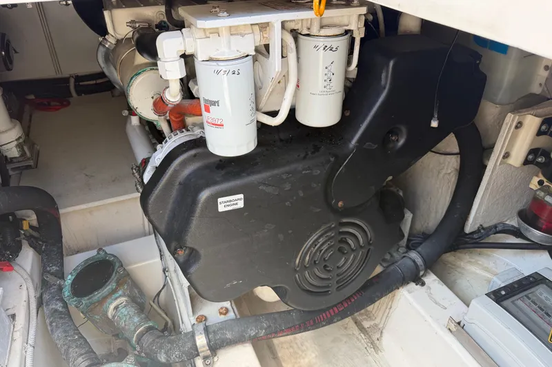 Slide: The Image of Engine compartment of a 2007 Azimut 43 yacht, featuring filters and hoses. - 31
