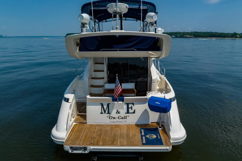 Slide: The Image of Azimut 43 yacht, 2007 model, docked on calm waters, rear view with American flag. - 4