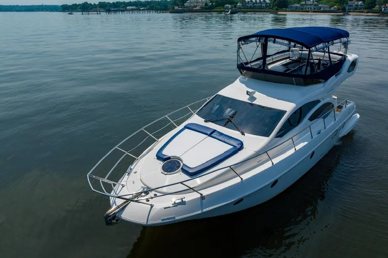 Slide: The Image of 2007 Azimut 43 yacht with blue canopy on calm waters. - 3