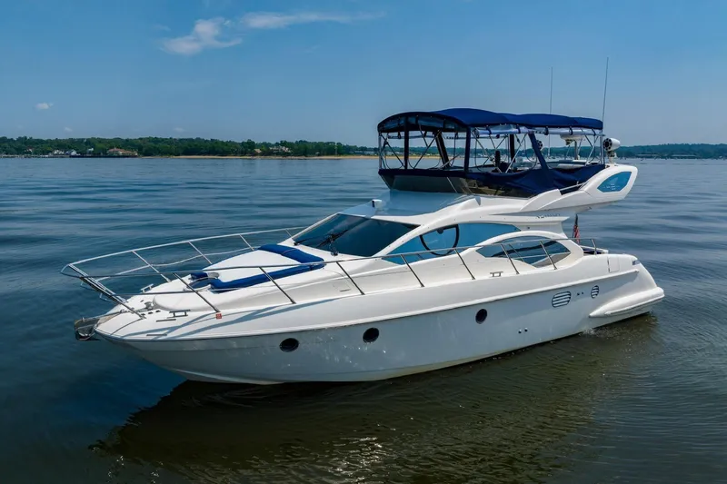 Slide: The Image of 2007 Azimut 43 yacht on calm water under clear blue sky. - 2