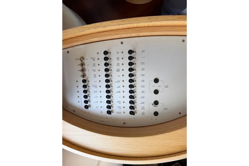 Slide: The Image of Control panel of a 2007 Azimut 43 yacht, featuring various switches and dials. - 27