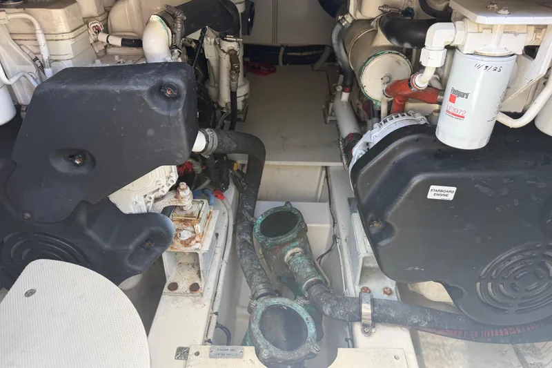 Slide: The Image of Engine compartment of a 2007 Azimut 43 yacht, showcasing mechanical components and piping. - 32