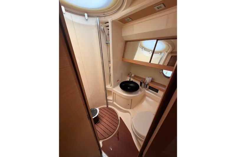 Slide: The Image of Luxurious bathroom in 2007 Azimut 43 yacht with modern fixtures and wooden accents. - 22